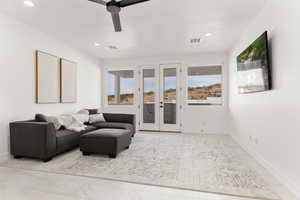 Living area featuring french doors, a ceiling fan, and recessed lighting
