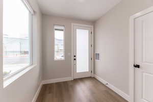 Entryway featuring wood finished floors and baseboards