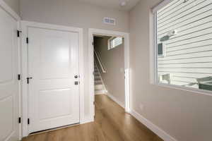 Foyer featuring light wood-style flooring and stairs