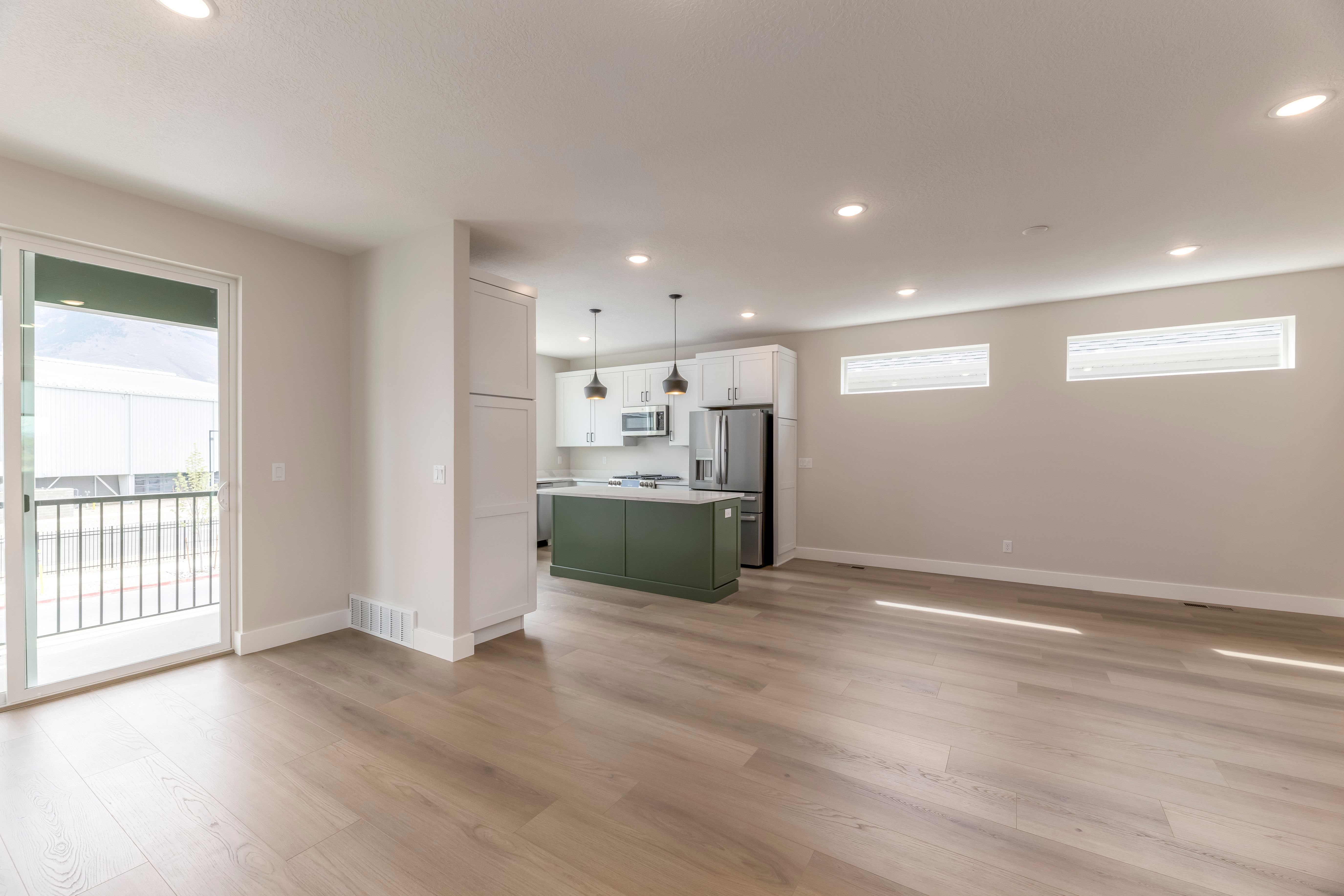 Unfurnished living room featuring light wood-style floors, recessed lighting, and plenty of natural light