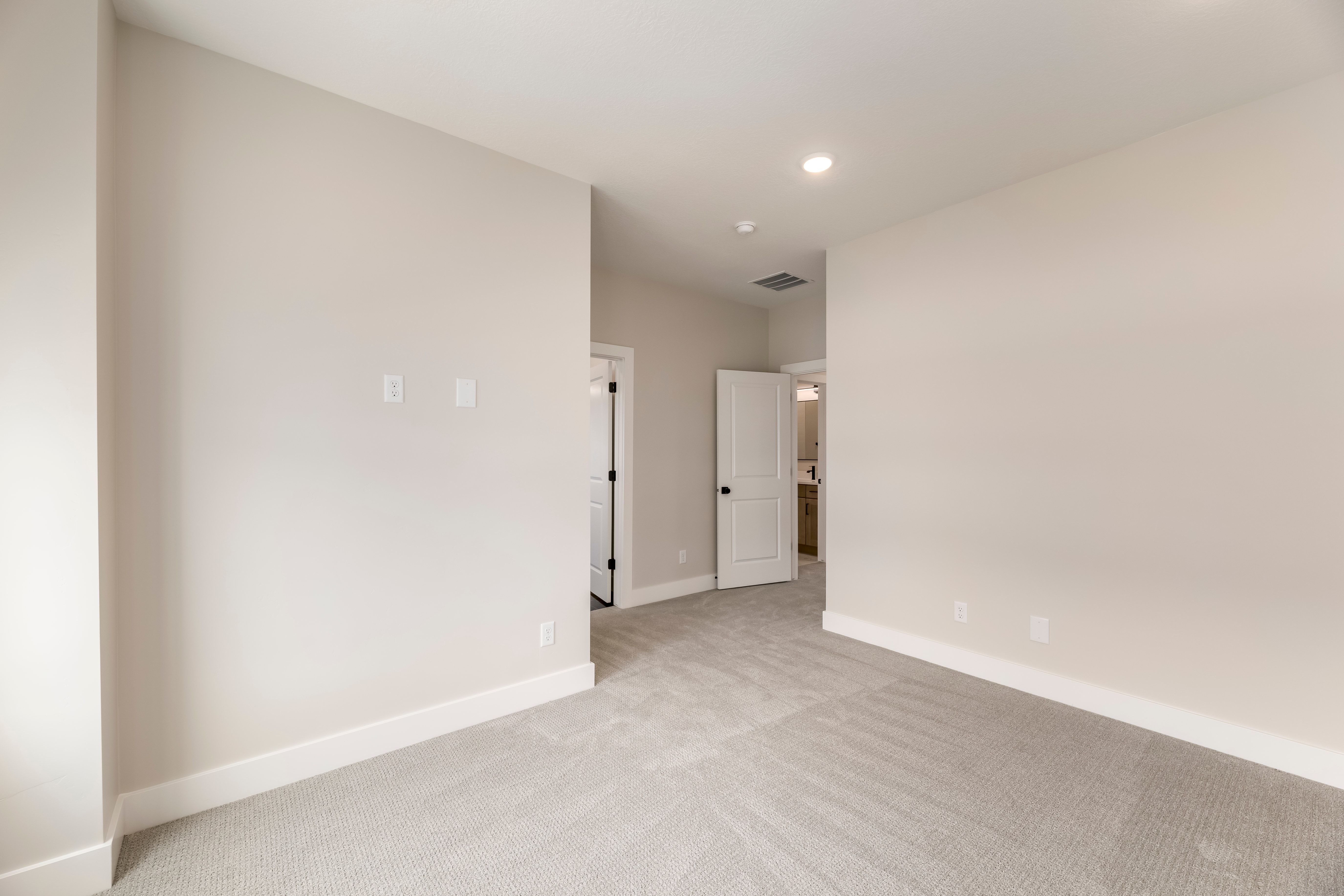 Spare room with light carpet and recessed lighting