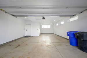 Garage with baseboards and recessed lighting