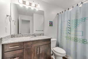 Full bathroom with vanity and a shower with shower curtain