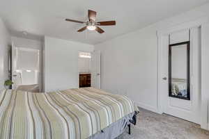 Bedroom featuring light colored carpet and a ceiling fan