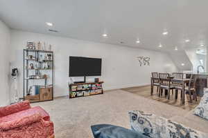 Living area featuring recessed lighting and light colored carpet