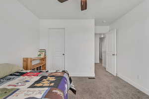 Bedroom with light colored carpet and ceiling fan