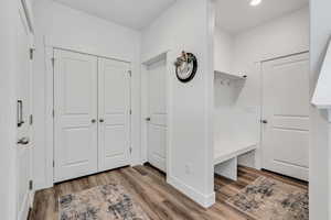 Mudroom featuring light wood-type flooring and recessed lighting
