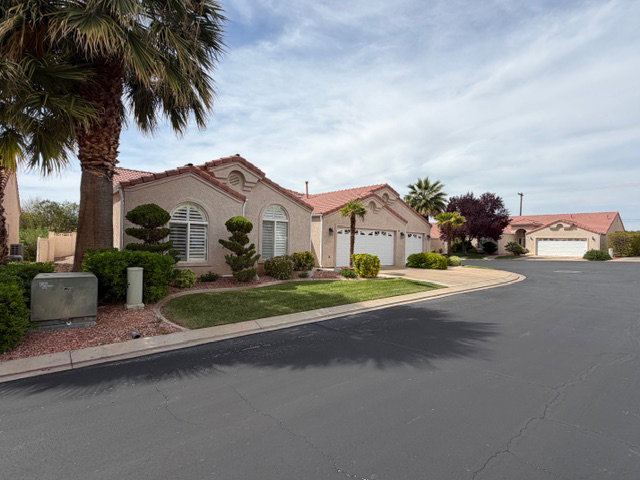 Mediterranean / spanish home with a tiled roof and stucco siding
