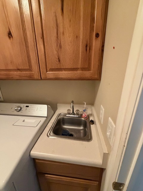 Laundry area featuring washer / clothes dryer and a sink