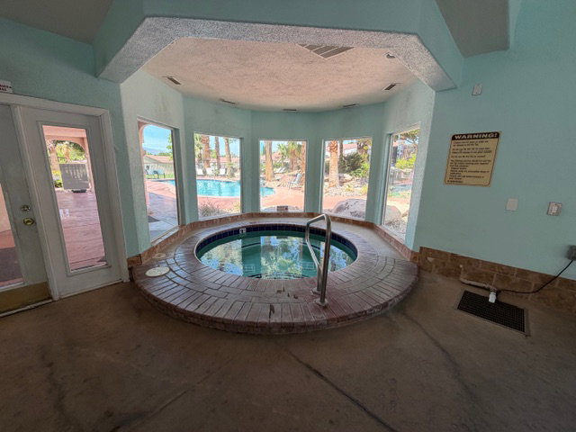 View of pool featuring a hot tub
