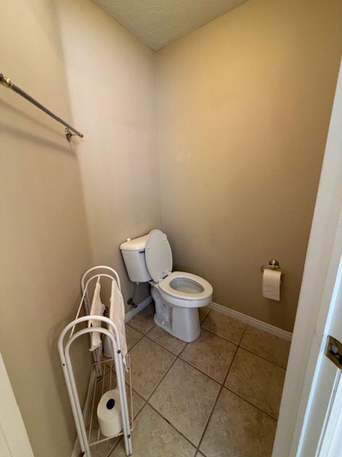Bathroom featuring light tile patterned floors and a textured ceiling