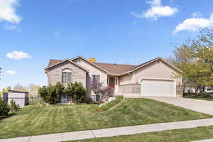 Single story home with a garage, brick siding, concrete driveway, a chimney, and stucco siding