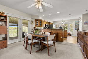 Dining room featuring light colored carpet, recessed lighting, and ceiling fan