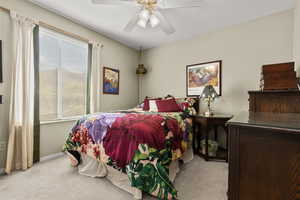 Bedroom with light carpet and ceiling fan