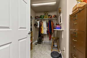 Walk in closet featuring light flooring