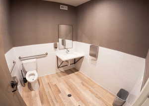 Bathroom featuring tile walls, a wainscoted wall, vanity, and light wood finished floors