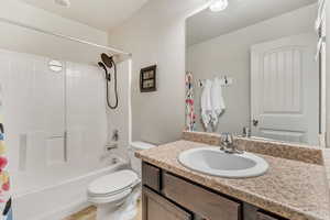 Bathroom featuring vanity and shower / tub combo with curtain