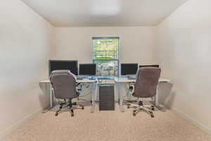 Office area with light carpet and baseboards