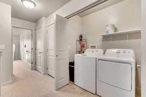Laundry area featuring washer and dryer and baseboards