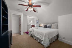 Bedroom featuring lofted ceiling, light carpet, and a ceiling fan