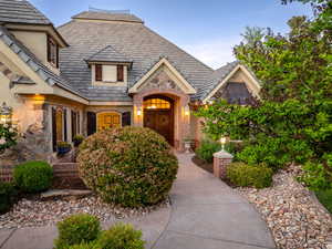 View of front facade featuring brick siding and stone siding