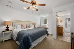 Bedroom with light colored carpet, recessed lighting, ceiling fan, and light tile patterned floors