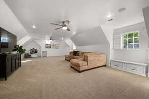 Sitting room featuring a ceiling fan, lofted ceiling, light colored carpet, healthy amount of natural light, and recessed lighting