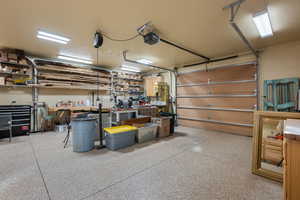 Garage with a workshop area and a garage door opener