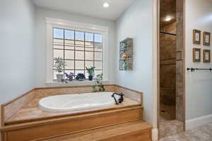 Full bathroom with a garden tub and a walk in shower