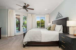 Bedroom with light carpet, ornamental molding, access to outside, french doors, and a ceiling fan
