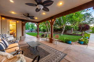 Fenced backyard with a patio, a ceiling fan, an outdoor hangout area, and a playground