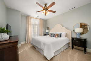 Bedroom featuring light carpet and ceiling fan