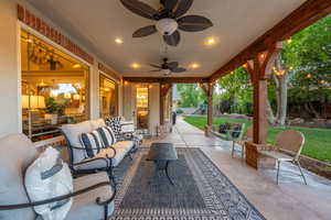 View of patio with outdoor lounge area and ceiling fan