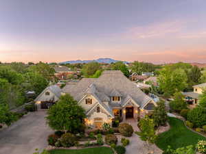 View of front of home featuring stone siding, concrete driveway, and stucco siding