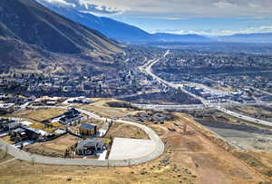 Aerial overview of property's location featuring mountains and nearby suburban area
