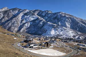 View of mountain backdrop featuring nearby suburban area