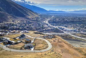 Aerial overview of property's location featuring mountains and nearby suburban area