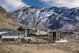 View of mountain backdrop featuring nearby suburban area