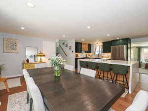 Dining room featuring recessed lighting, healthy amount of natural light, and light wood finished floors