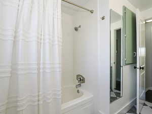 Full bathroom with shower/bath combo with shower curtain