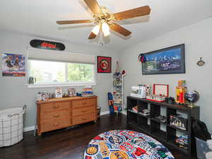 Bedroom with dark wood-type flooring and ceiling fan