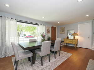 Dining space with recessed lighting and dark wood-style flooring