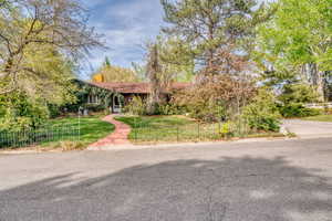 View of front of property with a front yard and a chimney