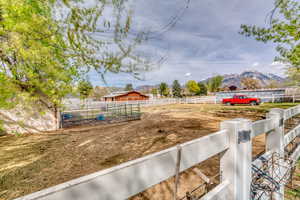 View of yard featuring a mountain view and an outbuilding