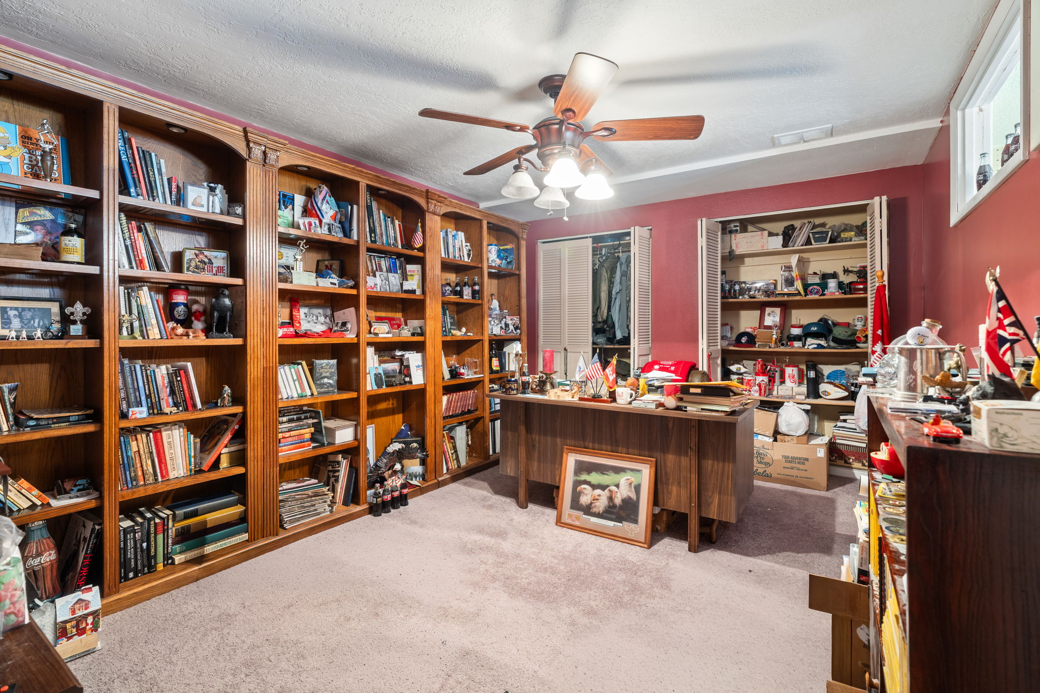 Office area featuring light colored carpet, a ceiling fan, and a textured ceiling
