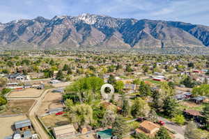 Aerial view of property's location featuring a mountainous background and nearby suburban area