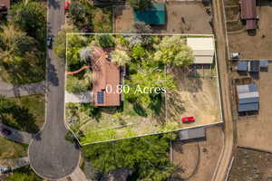 Aerial view of property and surrounding area featuring property parcel outlined