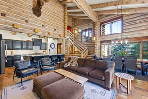 Living room featuring light wood-style floors and rustic walls