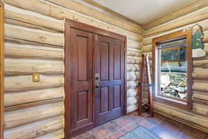 Foyer entrance with rustic walls