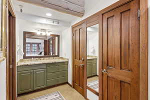 Bathroom featuring vanity, recessed lighting, and light carpet